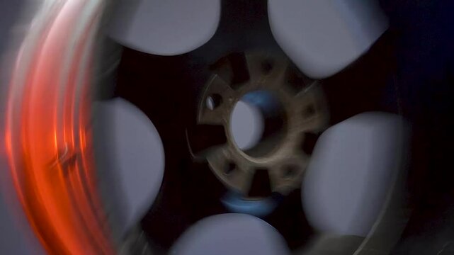 stylish car titanium wheels of black color eighteenth radius in red light in a dark room