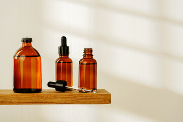 Collection of Amber Glass Dropper Bottles Displayed on a Minimalist White Surface in Natural Light