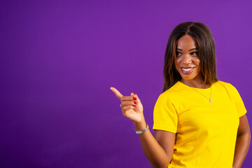 Urban young african woman indicating and pointing aside