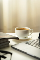 Modern Workspace With Laptop, Glasses, and Magazines