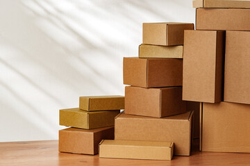 Stacked Cardboard Boxes On Wooden Surface In Sunlight