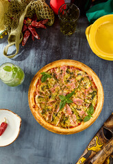Gourmet Smoked Salmon Pesto Pizza on Rustic Table with Fresh Basil and Colorful Background