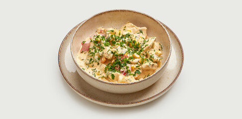 A classic Ukranian Olivier salad is presented in a beige bowl against a clean white background.