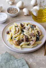 Penne pasta with mushrooms, spinach and cheese. Healthy food. Vegetarian food.