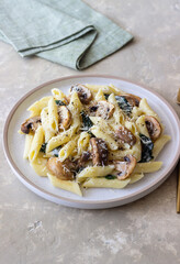 Penne pasta with mushrooms, spinach and cheese. Healthy food. Vegetarian food.