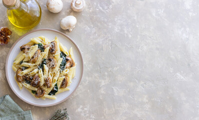Penne pasta with mushrooms, spinach and cheese. Healthy food. Vegetarian food.