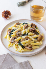 Penne pasta with mushrooms, spinach and cheese. Healthy food. Vegetarian food.