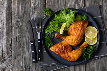 fried chicken legs with lettuce, lemon on plate