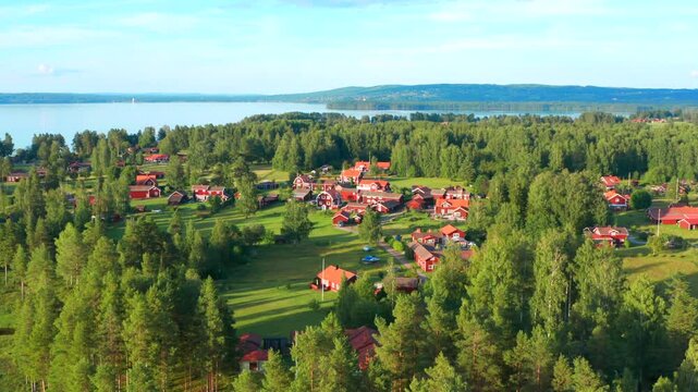 View of classical swedish landscape with traditional wooden red cabin cottage houses and camping site, Dalarna, Sweden on a summer sunny day