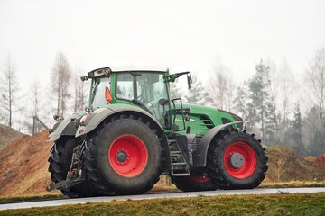Obraz premium Expensive European green tractor on a rural road