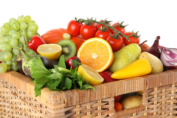Different fresh fruits and vegetables in wicker basket isolated on white