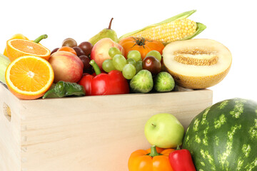Different fresh fruits and vegetables in wooden crate isolated on white