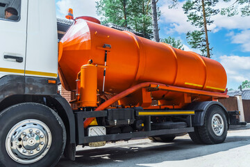 Sewage Tank truck. Sewer pumping machine. Red Septic truck. Pumping out sewage from a septic tank....