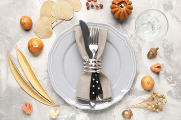 Stylish place setting with autumnal decor on grey textured table