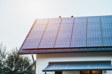 Efficient solar panel system installed on residential roof © AlexGo