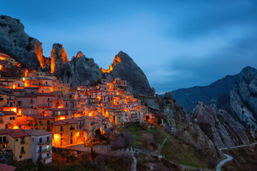 Castelmezzano village in the mountains at sunset with city lights