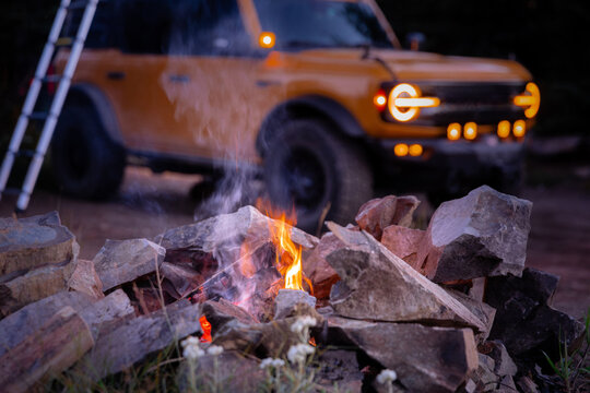 Campfire with yellow overlanding truck near Mt. Rainier, Washington