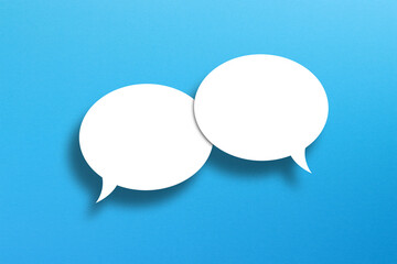 Blank white speech bubbles on blue background