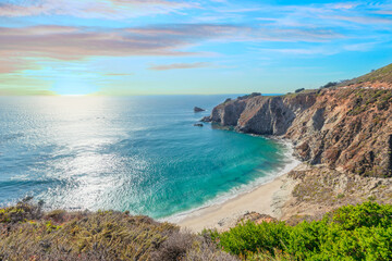 Fototapeta premium Beautiful landscape of Pacific Ocean coast along Highway 1 and Big Sur, aerial view, sunset, sunrise, fog. Concept, travel, vacation, weekend