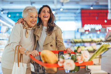 Joyful Grandmother and Granddaughter Shopping Together in Supermarket
