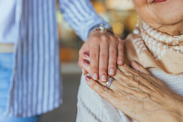 Close-Up of Elderly Hands with Supportive Younger Hand