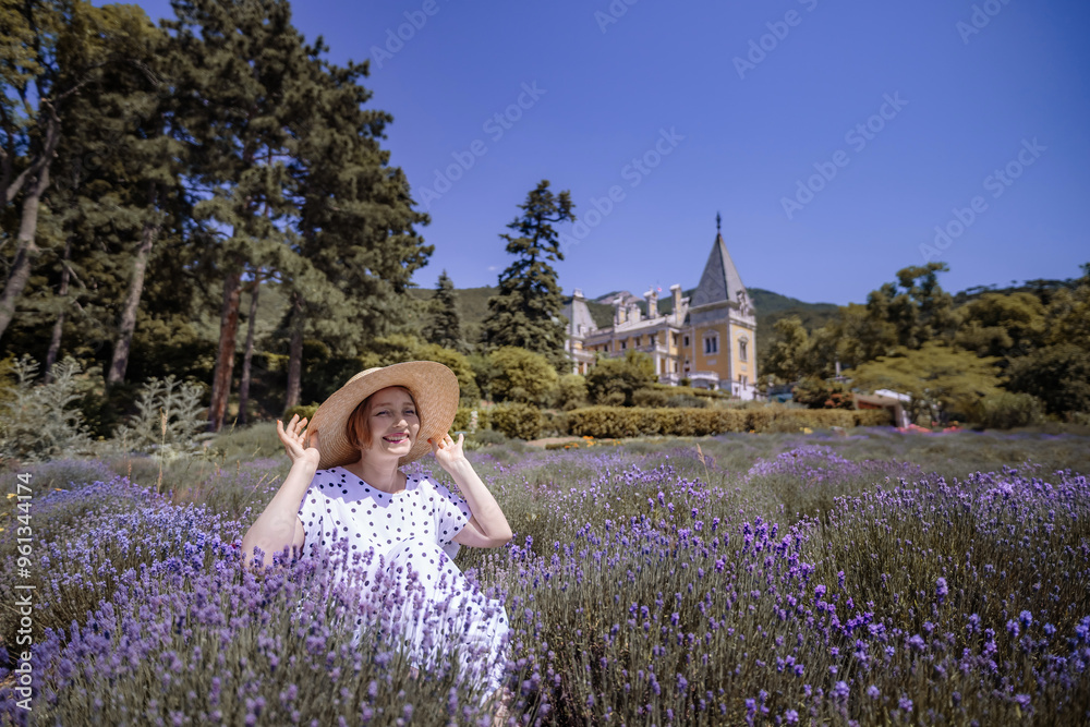 Canvas Prints a woman is sitting in a field of purple flowers