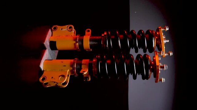 suspension tuning not new coilovers, shock absorbers and front springs in yellow and gold colors for a sports drift car on a dark background vertical video