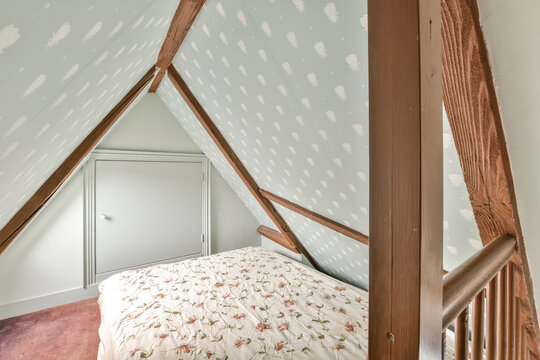 Cozy attic bedroom with floral bedding and wooden accents
