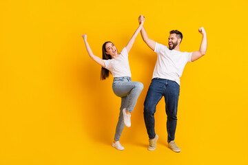 Full body photo of attractive young man woman hold hands winning dressed stylish white clothes...