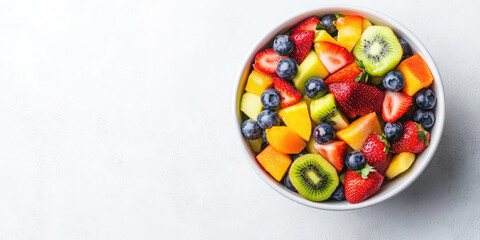 Vibrant fruit salad with strawberries, blueberries, mango, and kiwi on a dark background. Perfect for any time of day, packed with vitamins and antioxidants. Top-down view shows ripe, juicy fruits