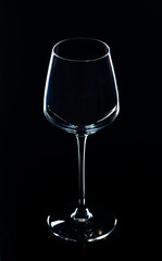 An empty wine glass on a black background