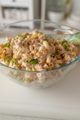 Homemade pasta tuna salad with corn, boiled eggs, onions and mayonnaise