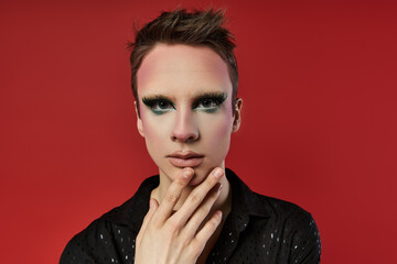 A vibrant drag artist expresses creativity through bold styling and pose.
