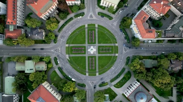 A top-down aerial view of Munich's Karolinenplatz, capturing its distinctive circular layout, central obelisk, and surrounding streets, offering a unique perspective of the city's urban design.