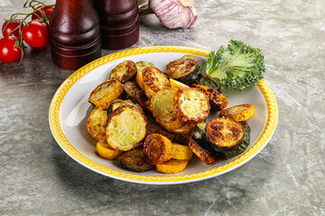 Roasted young zucchini in the plate