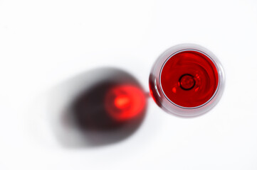 Shadow from a glass with red wine on a background.
