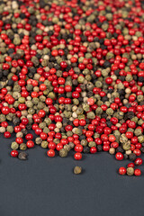 A mixture of different peppercorns white, black, red and green peppers spices.