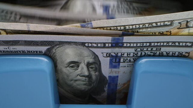 Counting cash in a bank with close-up shots of hundred-dollar bills during a busy afternoon