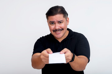 A middle-aged man insists to someone to accept his donation or gift. Handing over a envelope filled with money and pleading. Isolated on a white background.