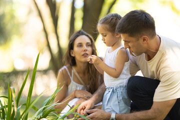 Fototapeta premium Family spending time together exploring nature in the park