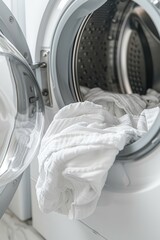 Close-Up View Of Laundry Being Loaded In A Front Loading Washing Machine At Home Laundry