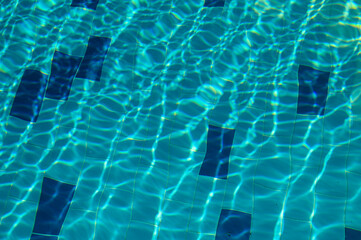 White reflections in motion on the water the pool.