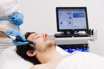 A man undergoes a hydrofacial treatment at a beauty clinic. This advanced procedure rejuvenates and revitalizes the skin, ideal for showcasing premium skincare services in your advertising.