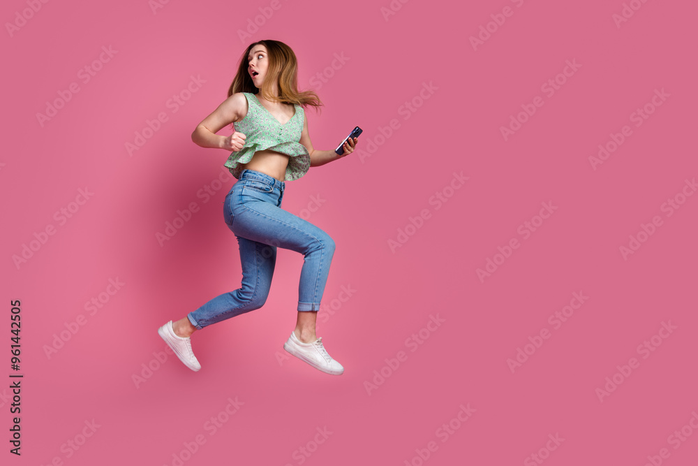 Sticker full size photo of nice young girl hold phone jump run away empty space wear top isolated on pink co