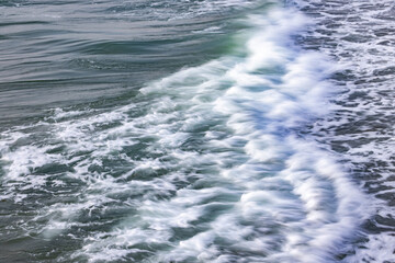close-up of waves on the Channel coast in Normandy, France, with low shutterspeed