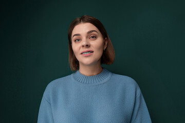 Fototapeta premium Woman in a Blue Sweater Looking Up