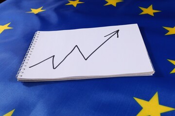 Growth trend chart on paper placed on European Union flag