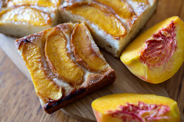 peach tart and fresh fruit closeup on wooden background horizontal view from above