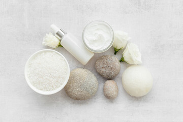 Blank white bottles of skin care cosmetics with roses