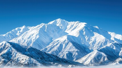 Snow Capped Mountains with Blue Sky and Fog